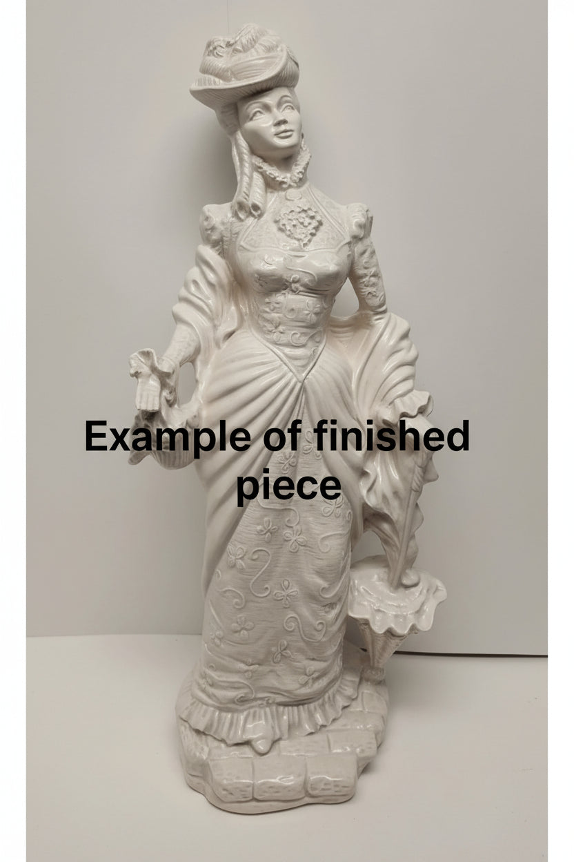 Decorative statue of a woman in an elaborate dress on a white background