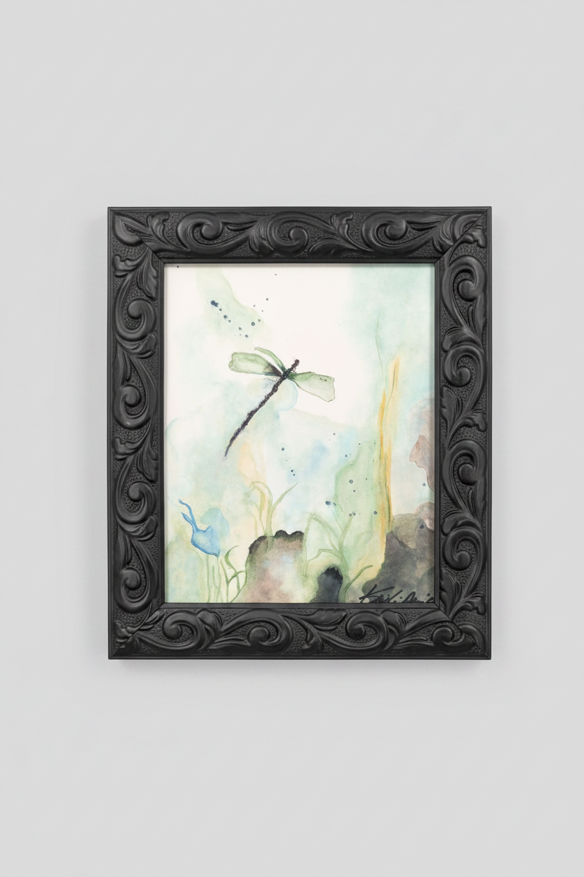 Framed artwork with a dragonfly on a watercolor background