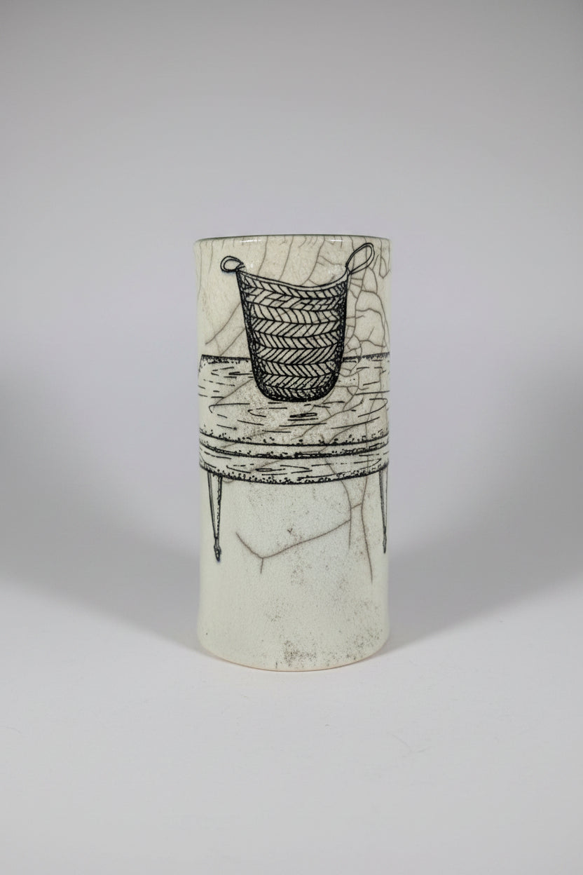 Cylindrical ceramic vase with black line art on a white background