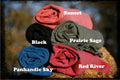 Stack of folded fabric in various colors with labels on a blurred natural background