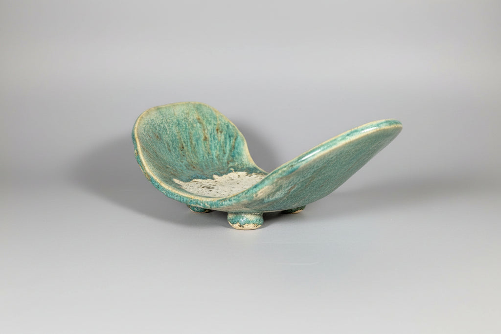 Green ceramic dish on a white background
