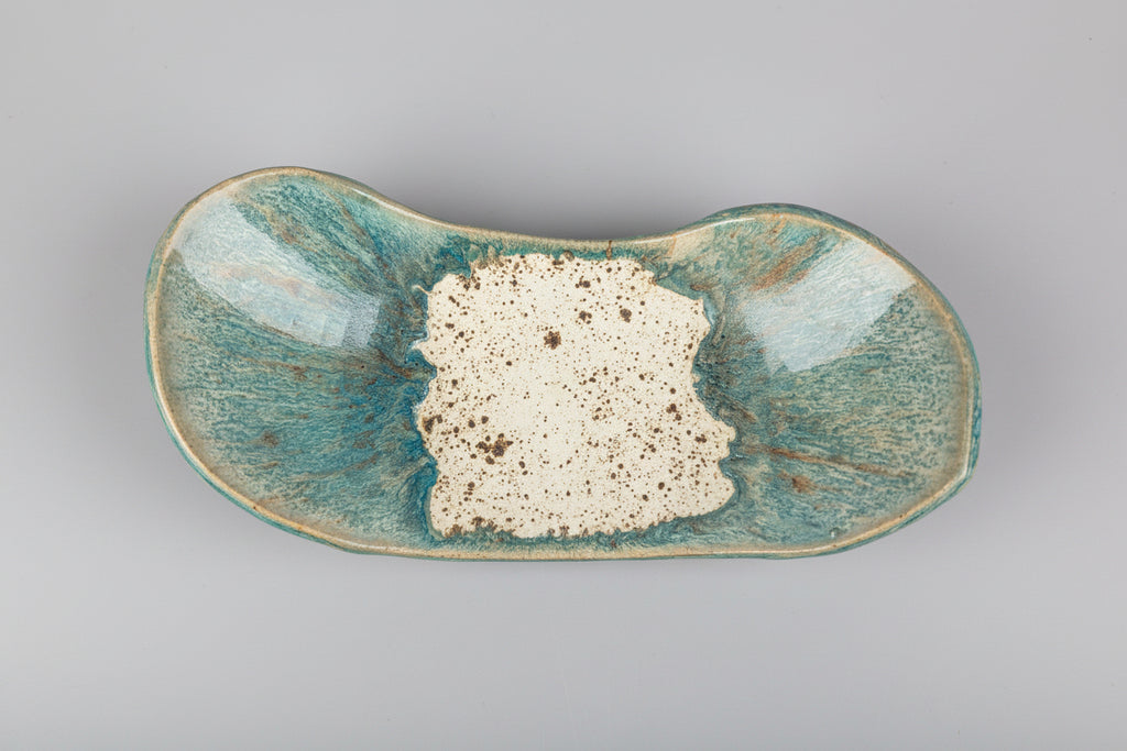 Ceramic dish with textured surface on a white background